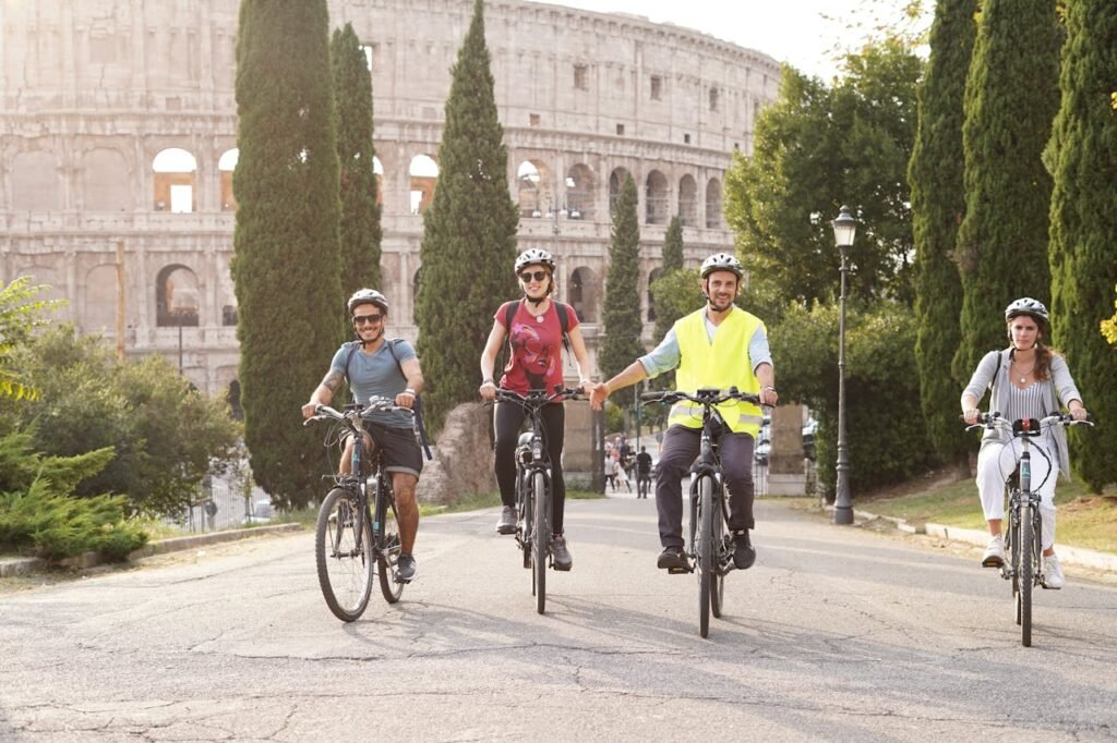 pexels-photo-15380193 A Group of People Riding on Bicycles in front of the Colosseum in Rome, Italy