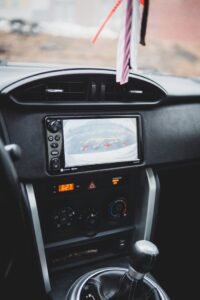 Modern dashboard of car with navigation display combined with multimedia system and selector